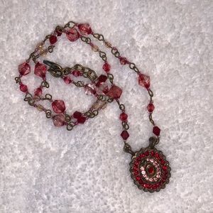 Pink & red beaded necklace with medallion